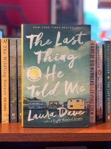 The Last He Told Me by Laura Dave sitting on a book shelf.